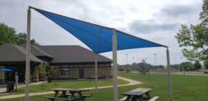 Shade Sail Example in a Park Covering Two Picnic Tables